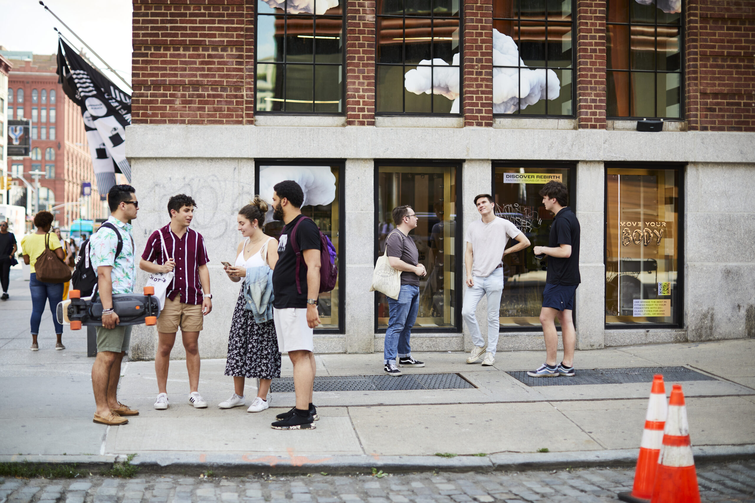 A large group of students hanging out on an NYC street.