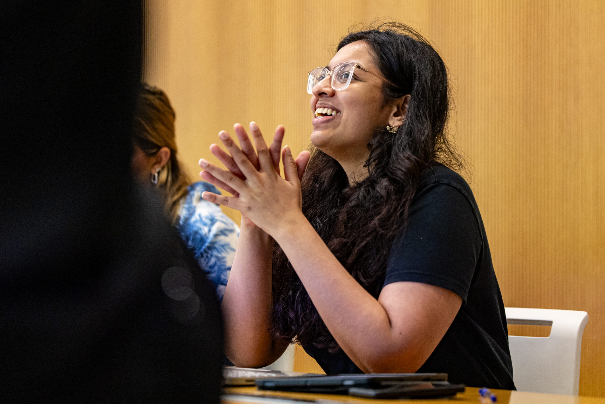 A student smiling in class.