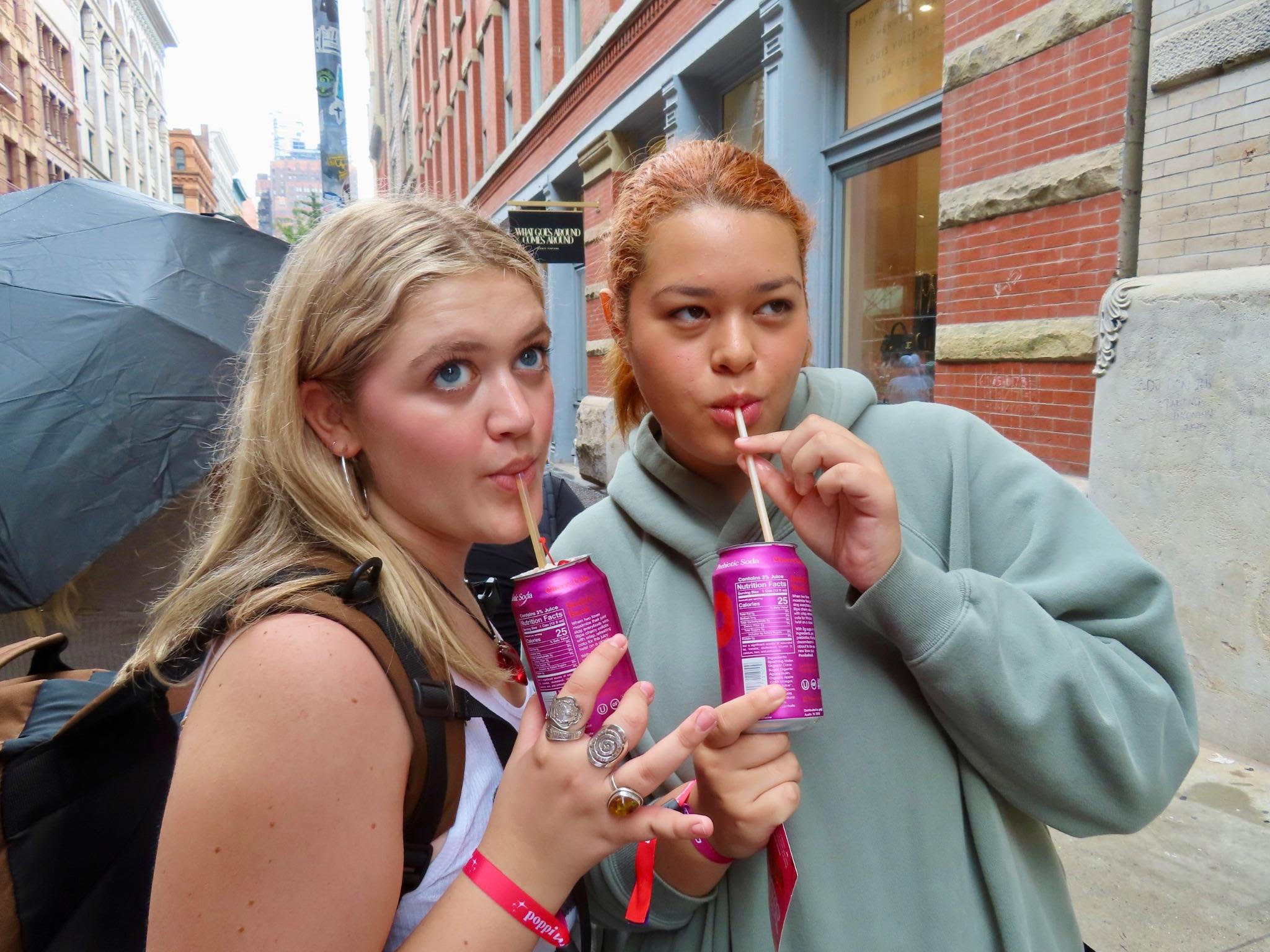 Two students posing with seltzer waters.
