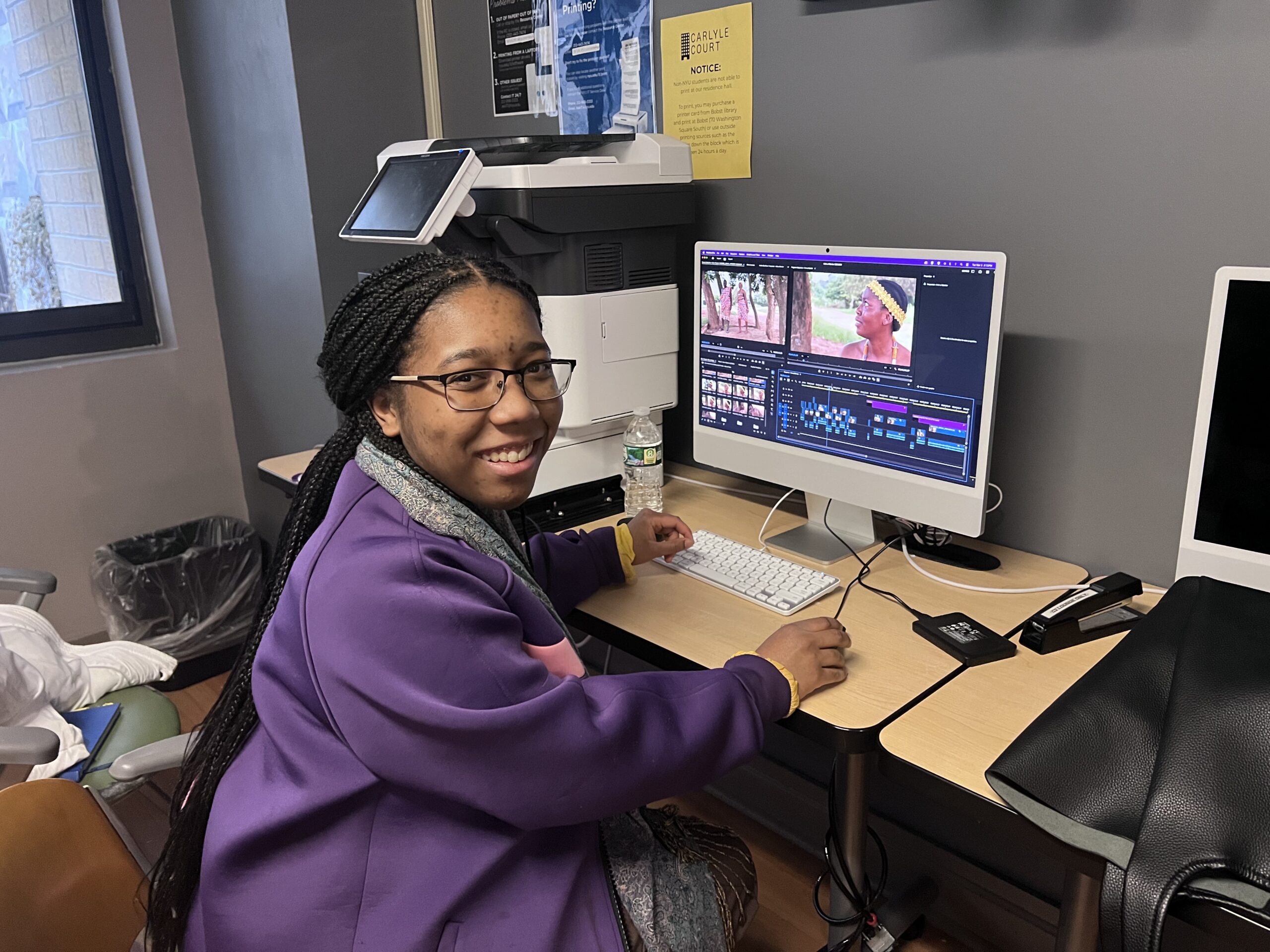 Ife smiling for the camera while editing a video