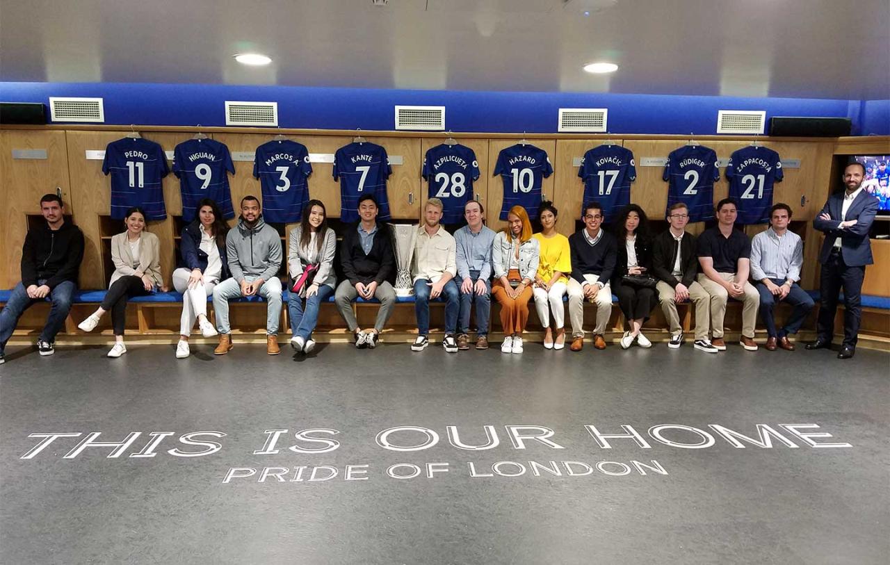 A group of Sport Management students sit in a locker room.