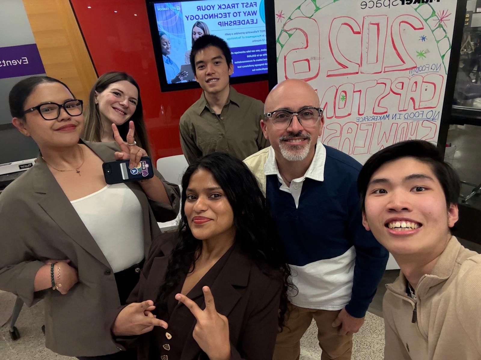 Campisi standing with a group of students taking a selfie
