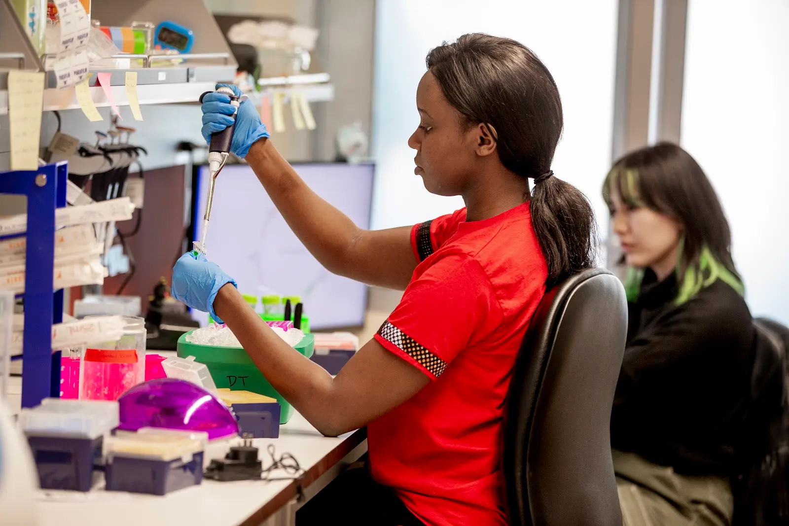 A student working with a pipette in a lab