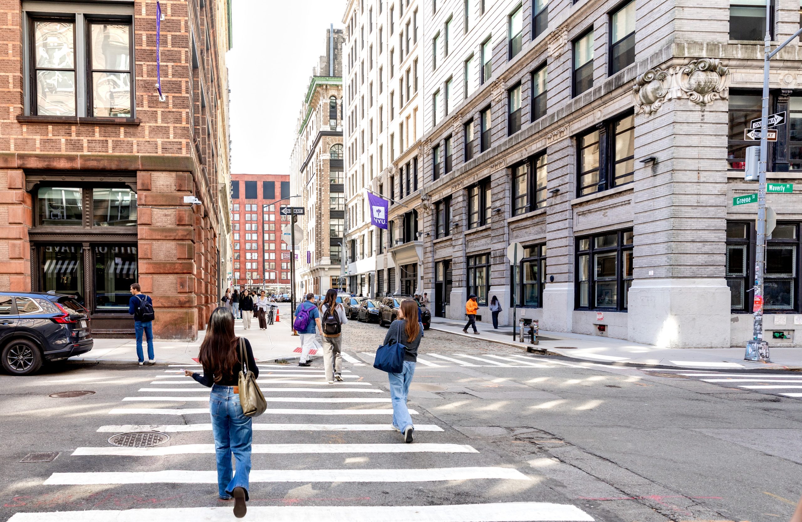 Students walking through the streets of NYU's Washington Square Park campus.